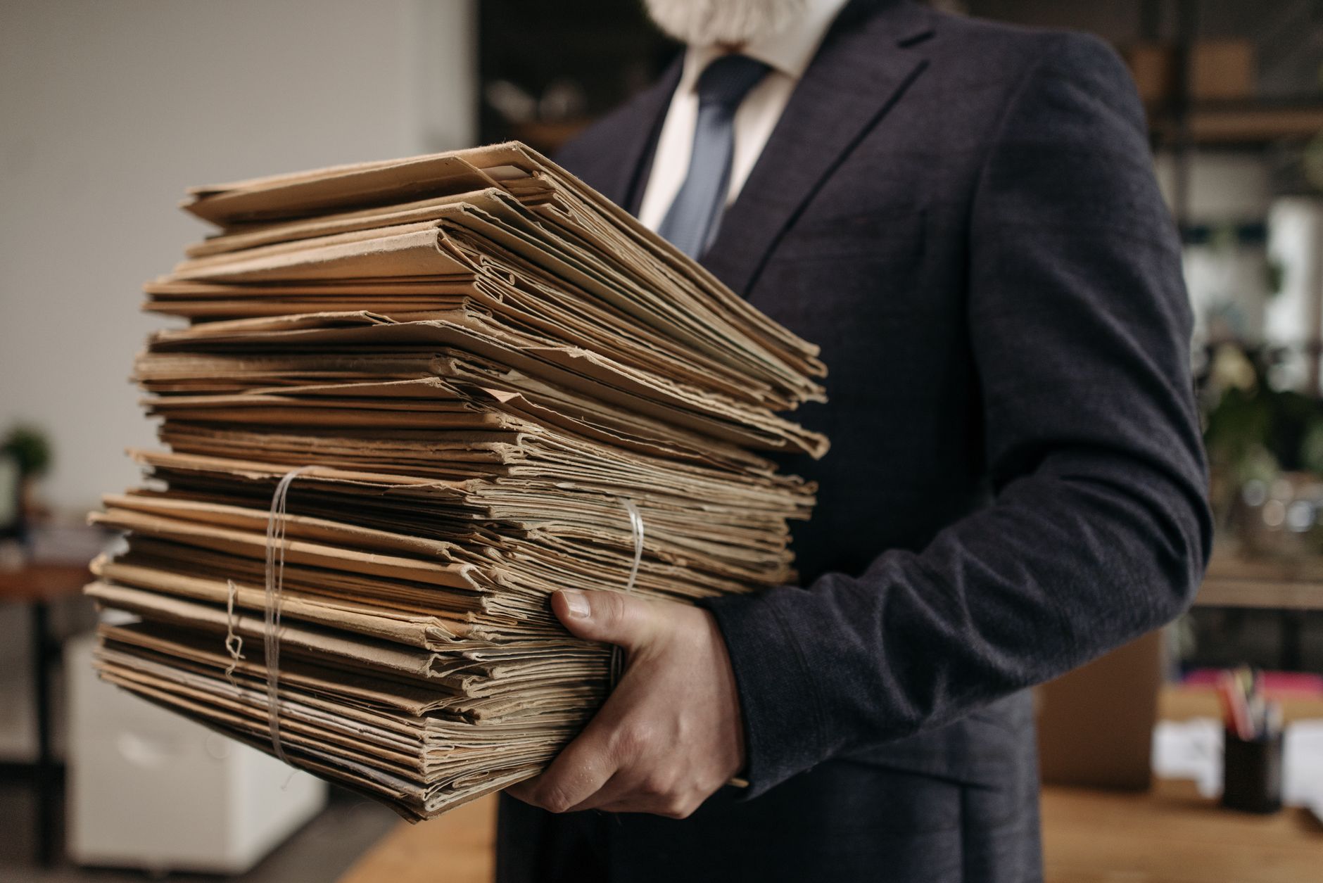 Dossiers et documents empilés sur un bureau.